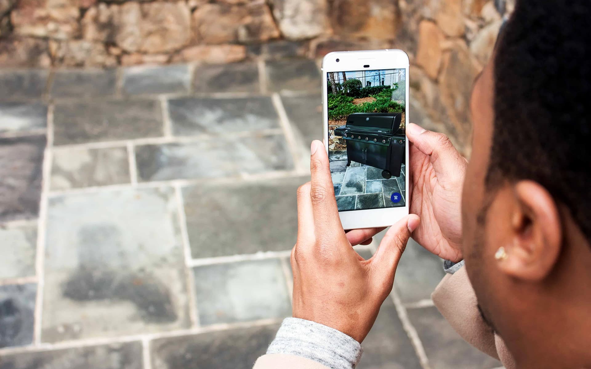Male customer checking Lowe’s consumer AR app for his future bbq purchase